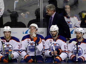 Edmonton Oilers coach Todd McLellan, top, and his players watch from the bench in the closing minutes of a 7-0 loss to the San Jose Sharks in Game 4 of a first-round NHL hockey playoff series Tuesday, April 18, 2017, in San Jose, Calif.