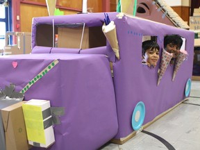 Priyank LNU, left, and Abishek Vijay Vinod Sankari, right, peak out from inside of an ice cream truck made out of cardboard boxes. The students took part in Not a Box Day at Ellerslie Campus at 521 66 Street SW in Edmonton, Alta., on Wednesday, April 19, 2017. Claire Theobald / Postmedia