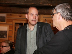 NDP leadership candidate Guy Caron chats with former MP Claude Gravelle at a meet and greet at MIC restaurant in this file photo. (Gino Donato/Sudbury Star)
