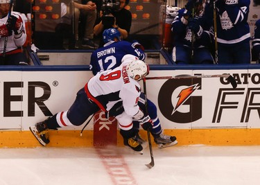Washington Capitals Alex Ovechkin LW (8) takes Toronto Maple Leafs�Connor Brown RW (12) into the boards during the second period of Game 4 in Toronto on Wednesday April 19, 2017. Jack Boland/Toronto Sun/Postmedia Network