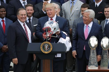 WASHINGTON, DC - APRIL 19:  New England Patriots Head Coach Bill Belichick (L) and team owner Robert Kraft (R) present a football helmet to U.S. President Donald Trump during a celebration of the team's Super Bowl victory on the South Lawn at the White House April 19, 2017 in Washington, DC. It was the team's fifth Super Bowl victory since 1960.  (Photo by Chip Somodevilla/Getty Images)