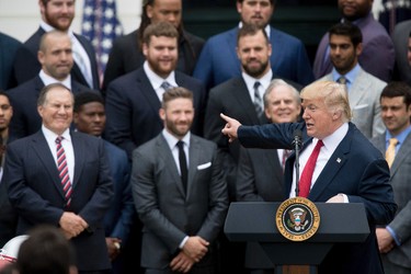 President Donald Trump points to New England Patriots head coach Bill Belichick, left, during a ceremony on the South Lawn of the White House in Washington, Wednesday, April 19, 2017, where he honored the Super Bowl Champion New England Patriots for their Super Bowl LI victory. (AP Photo/Andrew Harnik) ORG XMIT: DCAH107
