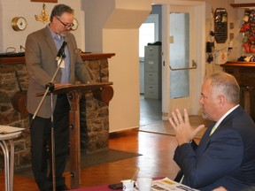 BRUCE BELL/THE INTELLIGENCER
Prince Edward - Hastings MPP Todd Smith (right) listens as Prince Edward County Chamber of Tourism and Commerce president Gil Leclerc addresses the audience at the organization’s annual general meeting on Thursday morning. Smith was the quest speaker and told the crowd at the Prince Edward Yacht Club the province's energy sector is a huge mess.