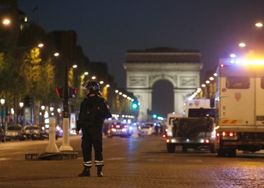 A police officer stands guard after a fatal shooting on the Champs Elysees in Paris, France, Thursday, April 20, 2017. (AP Photo/Thibault Camus)