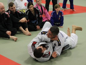 Photo by Jesse Cole Reporter/Examiner
Brazilian-born Jiu Jitsu master Max Trombini (top) grapples with a student at Rodrigo Resende’s Spruce Grove dojo during a weekend martial arts seminar. Trombini’s class focused on building the foundation of self defense with Spruce Grove students.