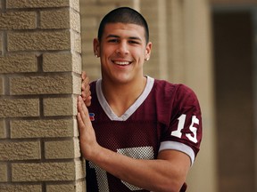 In this Dec. 12, 2005 photo, Aaron Hernandez poses for a photo in Bristol, Conn. Hernandez, a former NFL star, who was serving a life sentence for a murder conviction and Friday, April 14, 2017, was acquitted of a double murder, died after hanging himself at the prison early Wednesday, April 19, 2017, Massachusetts prisons officials said. (Patrick Raycraft/Hartford Courant via AP)