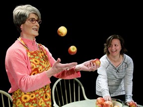 Carl Whelan, as the title character, shows Dominque Kamras, playing Molly, how to juggle in Ms. Cransen, written by Tricia West at the Arts Project. (MIKE HENSEN, The London Free Press)