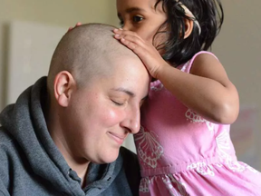 Addison kissing Julia Wagg's head during conditioning chemotherapy before a stem cell transplant in May 2016.