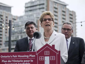 Ontario Premier Kathleen Wynne, centre, is joined by Ontario Finance Minister Charles Sousa, left, and Ontario Housing Minister Chris Ballard in Toronto on Thursday, April 20, 2017 to speak about Ontario's Fair Housing Plan. It's a lacklustre plan, affixing Toronto solutions to the entire province, writes the editorial board. CHRISTOPHER KATSAROV / THE CANADIAN PRESS