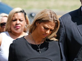 Racquel Smith, widow of former New Orleans Saints star Will Smith, arrives at the Orleans Parish criminal courthouse on  April 20, 2017, in New Orleans, with supporters, for the second day of a sentencing hearing for Cardell Hayes, who killed her husband and shot her, and was convicted of manslaughter. (AP Photo/Gerald Herbert)