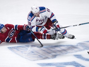 New York Rangers centre J.T. Miller (10) falls over Montreal Canadiens right wing Brendan Gallagher (11) during third period of Game 5 NHL Stanley Cup first round playoff hockey action in Montreal on Thursday, April 20, 2017. THE CANADIAN PRESS/Paul Chiasson
