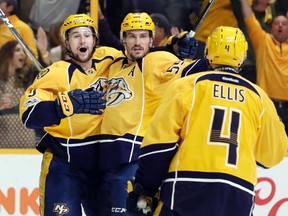 Nashville Predators defenseman Roman Josi (59), of Switzerland, celebrates with Filip Forsberg (9), of Sweden, and Ryan Ellis (4) after Josi scored against the Chicago Blackhawks during the second period in Game 4 of a first-round NHL hockey playoff series Thursday, April 20, 2017, in Nashville, Tenn. (AP Photo/Mark Humphrey)