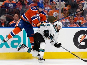 Edmonton Oilers forward Patrick Maroon takes San Jose Sharks' David Schlemko out of the equation at Roger Place in Edmonton on Thursday, April 20, 2017. (David Bloom)