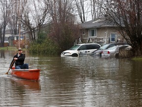 Rejean Belcourt paddles down Saint-Francois-Xavier Street  Gatineau in a canoe Friday April 21, 2017. More rain Friday caused more flooding in Gatineau. Rejoin decided to make the best of it as he paddled around the block he lives on Friday.