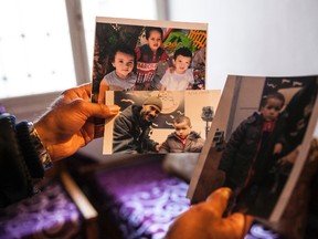 In this Wednesday, Feb. 3, 2017 photo, in Tunis, Tunisia, Faouzi Trabelsi shows a photo of himself with his grandson, Tamim Jaboudi, who has been trapped in a prison in Libya. The boy's Tunisian parents left home to join the Islamic State group and died in an American airstrike in February 2016. (AP Photo)