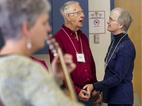 Paul and Janice Bertrand sing while Jennifer Noxon leads the Minds in Song group.