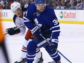 Auston Matthews of the Toronto Maple Leafs gets around Cam Atkinson of the Columbus Blue Jackets during NHL action at the Air Canada Centre in Toronto on April 9, 2017. (Dave Abel/Toronto Sun/Postmedia Network)