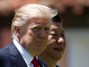 U.S. President Donald Trump, left, and Chinese President Xi Jinping walk together at Mar-a-Lago in Palm Beach, Fla. Following his meeting with Xi, Trump stepped on a historical land mine when he told the Wall Street Journal that “Korea actually used to be a part of China.” (Alex Brandon/The Associated Press)