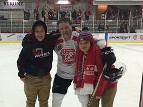George Kakeway (centre) poses with his grandsons Egan and Emry during a Kenora Thistles alumni game during the Hockey Day in Canada in Kenora.