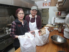 Joan and Kenny Chow work in the kitchen of their New China Doll Restaurant and Tavern on Thursday. The restaurant will close on April 30 after 53 years in business. (Ian MacAlpine/The Whig-Standard)