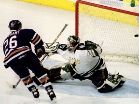 Edmonton Oilers forward Todd Marchant scores the fourth and winning goal for his team as Dallas Stars' goalkeeper Andy Moog tries to block the puck, April 29, 1997.