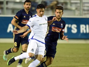 FC Edmonton midfielder Dustin Corea plays the ball in front of  North Carolina FC midfielder Nazmi Albadawi in North American Soccer League play on Saturday, April 15 at WakeMed Soccer Park in Cary, North Carolina. North Carolina FC won 3-1.