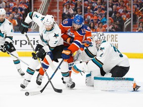 Patrick Maroon #19 of the Edmonton Oilers battles against Paul Martin #7 and goalie Martin Jones #31 of the San Jose Sharks in Game Five of the Western Conference First Round during the 2017 NHL Stanley Cup Playoffs at Rogers Place on April 20, 2017.