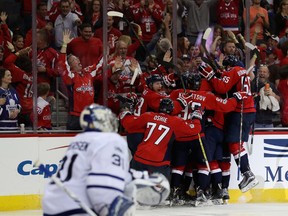Capitals’ overtime hero Justin Williams is mobbed by teammates after scoring the game-winning goal to give them a 3-2 series lead over the Maple Leafs. (Getty Images)