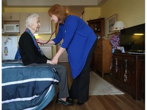 Nurse Susan Hagar listens to Janet Lee's heart in Ottawa. Hagar operates a company called Nurse On Board that offers nurses for hire for patients and their families to help them navigate the health care system.