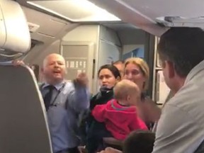 An American Airlines flight attendant is seen in a shouting match with a passenger in this video screenshot. (Surain Adyanthaya/Facebook video screenshot)