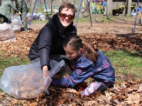 Terri King and her niece Rebecca Jubenville, 9, lend a hand cleaning up Canatara Park Saturday. More than 650 people turned out for Sarnia's third annual Community Parks Clean-Up Day, rolling their sleeves up to tidy up 23 city parks and the Howard Watson Nature Trail. Barbara Simpson/Sarnia Observer/Postmedia Network