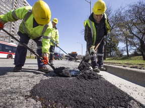 Road crew out on Finch Ave near Warden filling potholes on Tuesday April 18, 2017. (Craig Robertson/Toronto Sun)