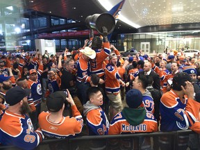 Fans celebrate while surround the statue of Wayne Gretzky outside Rogers Place stadium after the Edmonton Oilers defeated the San Jose Sharks in overtime on April 21, 2017. (Ed Kaiser)