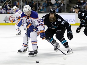 Edmonton Oilers forward Ryan Nugent-Hopkins vies for the puck against San Jose Sharks' Joe Thornton on Jan. 26,, 2017, in San Jose, Calif. (AP Photo)