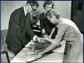 Cam Tait face down on the table with volunteers Tony White on the left, my mother Thelma turning my head and volunteer Audrey Hegleson on the right helping with an afternoon patter