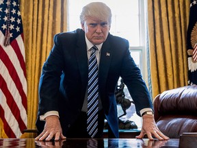 U.S. President Donald Trump poses for a portrait in the Oval Office in Washington, Friday, April 21, 2017.  (AP Photo/Andrew Harnik)