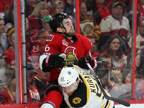Sean Kuraly of the Boston Bruins hits Chris Wideman of the Ottawa Senators during second period of NHL action held at Canadian Tire Centre in Ottawa, April 21, 2017. (Jean Levac/Postmedia)