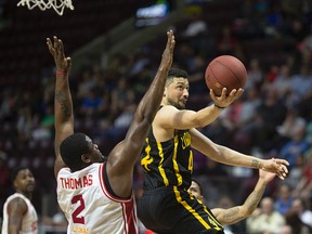 London's Ryan Anderson drives past Windsor's DeAndre Thomas during NBL of Canada action between the London Lightning and the Windsor Express at WFCU Centre, Sunday, April 23, 2017.  (DAX MELMER/Windsor Star)