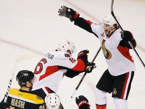 Senators' Clarke MacArthur (16) celebrates his game-winning goal with teammate Bobby Ryan (9) as Bruins' Riley Nash (20) looks on during overtime in Game 6 which eliminated the Bruins in the first-round playoff series in Boston on Sunday, April 23, 2017. (Michael Dwyer/AP Photo)