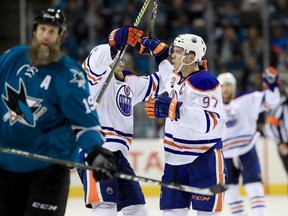 Connor McDavid #97 of the Edmonton Oilers and Leon Draisaitl #29 celebrate next to Joe Thornton #19 of the San Jose Sharks after McDavid scored an empty net goal at the end of the third period against the San Jose Sharks during Game Six of the Western Conference First Round during the 2017 NHL Stanley Cup Playoffs at SAP Center on April 22, 2017 in San Jose, California.