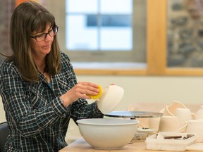 Lindsay Hadcock, a new artist in the Kingston Potters' Guild, glazes her pottery with a spring green colour to prepare the piece for the Spring Show and Sale, May 4-7. (Taylor Bertelink/For The Whig-Standard)