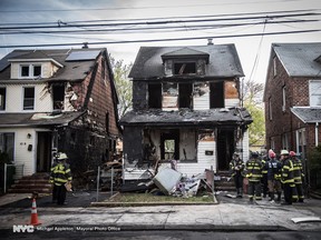 New York Fire Department personnel stand outside the scene of a deadly fire Sunday, April 23, 2017, in Queens Village in New York that killed multiple people, including children. The fire broke out Sunday afternoon on a street full of single-family homes in the middle class neighborhood of Queens Village. (Michael Appleton/Office of the Mayor via AP)