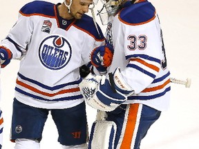 Edmonton Oilers defenseman Andrej Sekera (2) celebrates with Edmonton Oilers goalie Cam Talbot (33) after a 3-1 victory against the San Jose Sharks in Game 6 of a first-round NHL hockey playoff series Saturday, April 22, 2017, in San Jose, Calif. Edmonton Oilers wins the series 4-2.
