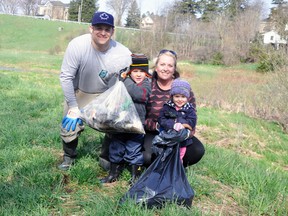 The Linton family, of Mitchell - dad Paul, mom Amanda, son Miles, 5 and daughter Grace 3 - took a moment to stop cleaning up the area around the Whirl Creek foot bridge last Saturday, April 22 during the West Perth Thames River cleanup. ANDY BADER/MITCHELL ADVOCATE