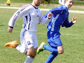 Dan Gethke (9) of St. Mike's senior boys soccer team battles Curtis Lockhart of Mitchell District High School’s (MDHS) varsity team during Huron-Perth soccer action last Tuesday, April 18 in Mitchell. The Warriors won 2-0. Earlier in the day, the Blue Devils dropped a 4-1 decision to South Huron, with Denzel Bolinger the lone goal scorer for Mitchell. ANDY BADER/MITCHELL ADVOCATE