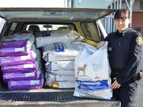 Chelsey Romain, an Ontario SPCA agent based in Timmins, unloads dog food being flown into Kashechewan. The Ontario SPCA responded to an urgent appeal from the Kashechewan First Nation for food for their resident dogs as the community evacuates from rising flood waters.