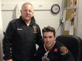 Scoring ace Greg Hay, seated, signs a contract with the Sarnia Legionnaires Jr. 'B' hockey club. Standing is head coach Mark Davis. (Holli Griffith photo)