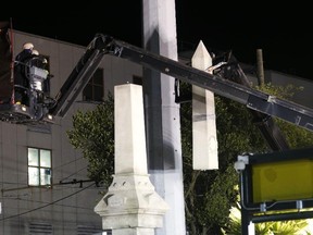 Workers dismantle the Liberty Place monument on Monday, April 24, 2017, which commemorates whites who tried to topple a biracial post-Civil War government, in New Orleans. (AP Photo/Gerald Herbert)