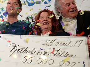 Nathalie Langlais (second from right) and Gilles Rosnen (second from left) celebrate with family members as they hold their winning $55-million lottery cheque in Montreal, Monday, April 24, 2017. The couple hid the winning ticket in their daughter's toy box over the weekend. THE CANADIAN PRESS/Ryan Remiorz