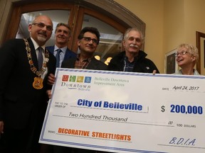 Jason Miller/The Intelligencer 
Mayor Taso Christopher (first left) collects a cheque for $200,000 (percentage of a $250,000 pledge), for downtown decorative lifting, from the BDIA executive. Also pictured, is BDIA board chair Dwane Barratt (second left), Mike Malachowski, Paul Dinkel and BDIA executive director, Marilyn Lawrie.  The city also received $250,000 commitment in 2015, towards downtown street lighting.